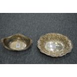 A silver pierced oval basket and a silver embossed oval dish.