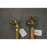 Two walking sticks, the brass handles modelled as a dog and a cat.