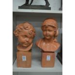 A pair of terracotta busts of children.