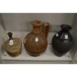 Studio pottery vase, an African carved wood jug and another vase.