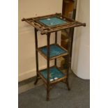 A bamboo stand with three tiers comprising three Minton turquoise glazed hunting tiles.
