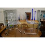 A set of four stylish perspex and chrome framed dining chairs.