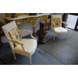 A pair of French style cream painted and upholstered open armchairs.