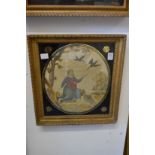 A silk work and part painted oval picture of a kneeling biblical figure in a gilt and verre eglomise