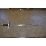 A sword with broad tapering triple fullered double edged blade, wire bound grip with plated brass