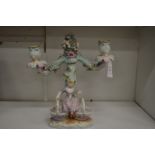 A Dresden porcelain figural two branch candelabra.