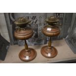 A pair of copper oil lamps.
