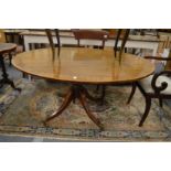 A mahogany oval tilt-top breakfast table.