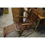 A teak steamer style garden lounger.