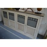 A stylish painted French four door low cupboard.