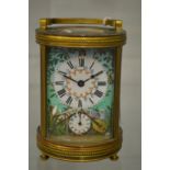 A good circular brass carriage clock with enamel decorated dial and case.