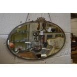 An oval wall mirror.