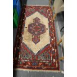 A Persian rug with geometric panels 200cm x 94cm.