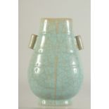 A CHINESE CELADON GUAN-TYPE VASE, with twin handles and character mark to base, 22cm high.