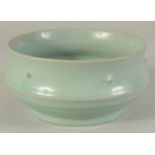 A GOOD CHINESE CELADON BOWL, the exterior with raised bosses and ribbed section beneath, 17cm