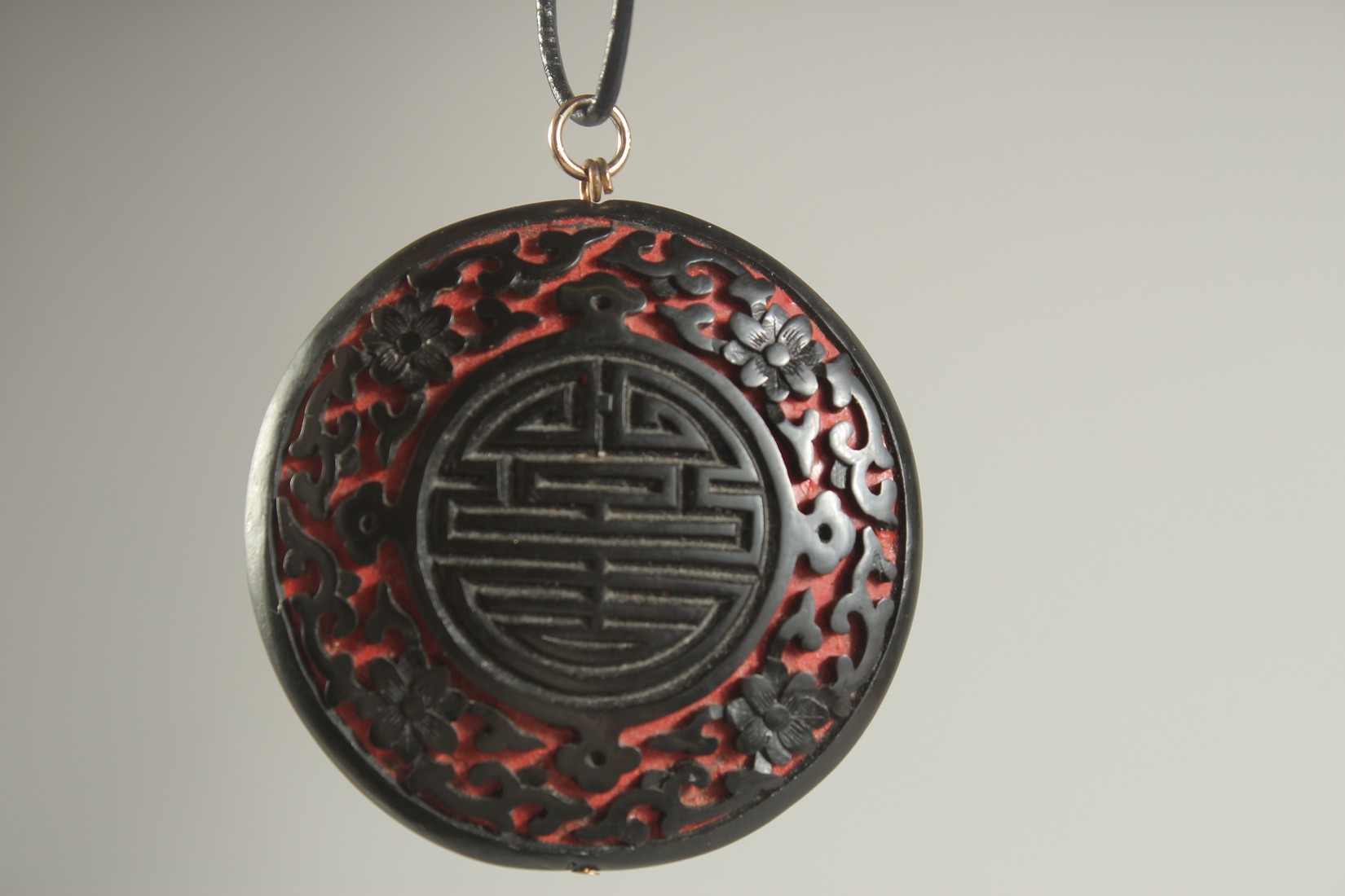 A CHINESE BLACK CINNABAR LACQUER PENDANT, 5cm diameter. - Image 2 of 2