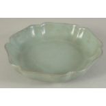 A CHINESE CELADON GLAZE PETAL-FORM DISH, 18cm wide.