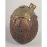 A FINE 19TH CENTURY PERSIAN QAJAR CARVED COCONUT HUQQA BASE, with engraved and chased brass mount,
