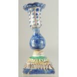 AN ISLAMIC GLAZED POTTERY CANDLESTICK, 16.5cm high.