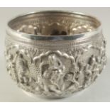 A 19TH CENTURY BURMESE SILVER BOWL, with fine repose figural decoration, 16cm diameter.