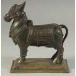 A 19TH CENTURY INDIAN BRONZE BULL NANDI, stood upon a rectangular base, 15cm long.