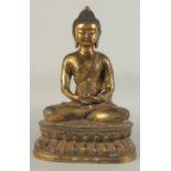 A LARGE GILT BRONZE SEATED BUDDHA, his robe with lucky symbols, 40.5cm high.