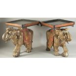 A PAIR OF GILDED AND PAINTED CARVED WOODEN ELEPHANT STANDS, 45cm high.