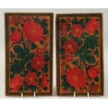 A PAIR OF PERSIAN LACQUER BOOK COVERS, painted with flowers, 28cm x 16cm.