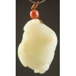 A FINE 18TH CENTURY CARVED JADE LOTUS ROOT PENDANT, with coral bead and hallmarked metal, 4.5cm