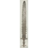 AN UNUSUAL 19TH CENTURY INDIAN SHORT SWORD, with silver inlaid calligraphic handle and serrated