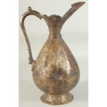 AN ENGRAVED SELJUK STYLE BRASS EWER, with bands of calligraphy, 34.5cm high.