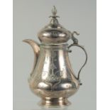A FINELY ENGRAVED 19TH CENTURY OTTOMAN TURKISH LOW GRADE SILVER COFFEE POT, 18.5cm high.