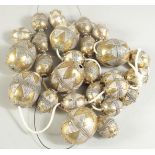 A COLLECTION OF GILDED WHITE METAL BEADS, various sizes.