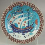 A TURKISH OTTOMAN GLAZED POTTERY PLATE, 31cm diameter.