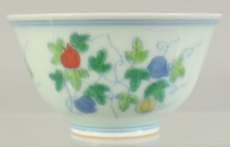 A CHINESE DOUCAI PORCELAIN CUP, decorated with fruits, 8.5cm diameter.