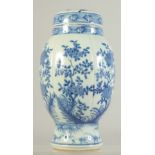 AN EARLY 20TH CENTURY BLUE AND WHITE PORCELAIN JAR AND COVER, decorated with panels of flora, 24.5cm