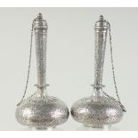 A FINE PAIR OF EARLY 19TH CENTURY NORTH INDIAN ENGRAVED SILVER LIDDED BOTTLES, 15.5cm high.