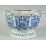 A 20TH CENTURY CHINESE OCTAGONAL BLUE AND WHITE JARDINIERE, decorated with floral motifs, 25.5cm