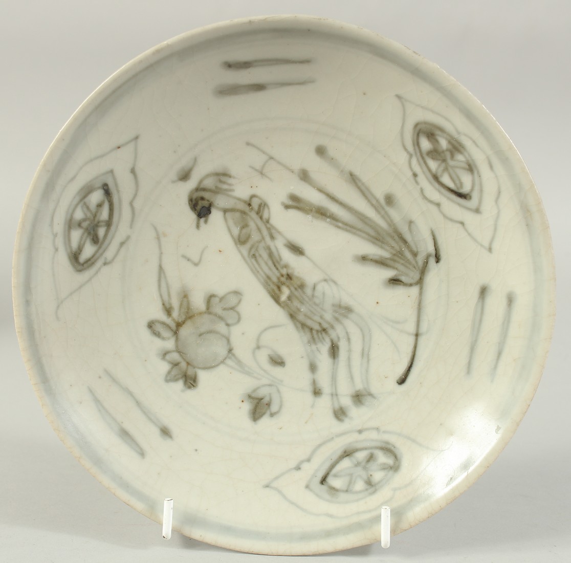 A CHINESE BLUE AND WHITE DISH, decorated with peacock and peach, with applied sticker to base, 20.
