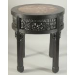 A CHINESE MARBLE INSET HARDWOOD STAND / TABLE, the skirt with carved and pierced panels of fruit and