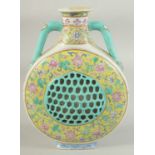 A 19TH CENTURY CHINESE FAMILLE JAUNE PORCELAIN TWIN HANDLE FLASK VASE, with pierced central panel a