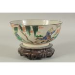 A CHINESE FAMILLE VERTE PORCELAIN BOWL - possibly Qing dynasty, with hardwood stand, the exterior