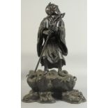 A LARGE 19TH CENTURY CHINESE BRONZE FIGURE OF LI TIEGUAI, elevated upon a large rock-formed bronze