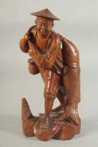 A CHINESE CARVED WOOD FIGURE OF A FISHERMAN, 26cm high.