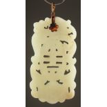 A 19TH CENTURY CHINESE CARVED AND PIERCED JADE PENDANT, with central longevity symbol, dragon and