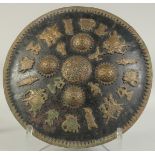 A FINE 19TH CENTURY INDIAN METAL SHIELD, with applied brass figural decoration and four raised brass