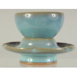 A CHINESE JUN WARE CUP ON PETAL-FORM STAND, cup 8cm diameter, 12cm diameter.