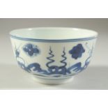 A SMALL 19TH CENTURY CHINESE BLUE AND WHITE PORCELAIN BOWL, painted with stylised waves and floral