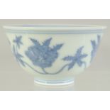 A CHINESE BLUE AND WHITE PORCELAIN CUP, with flora, character mark to base, 8cm diameter.