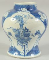 A CHINESE BLUE AND WHITE PORCELAIN JAR, painted with panels of vases and objects, character mark